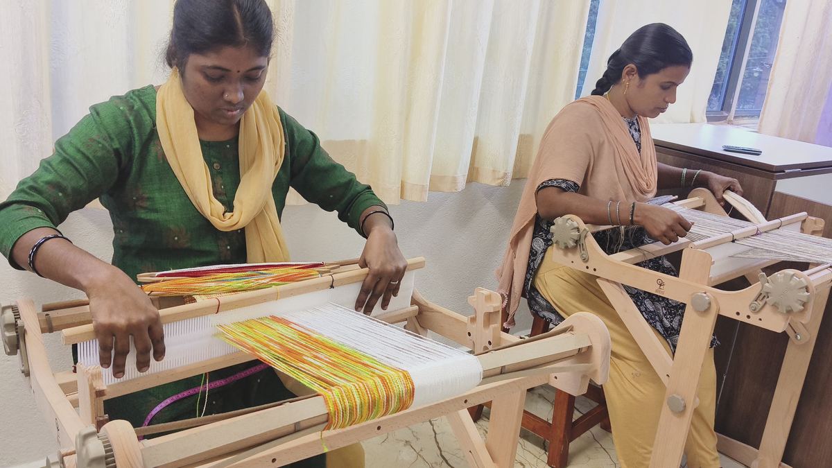 Women at weaving loom — craft skills